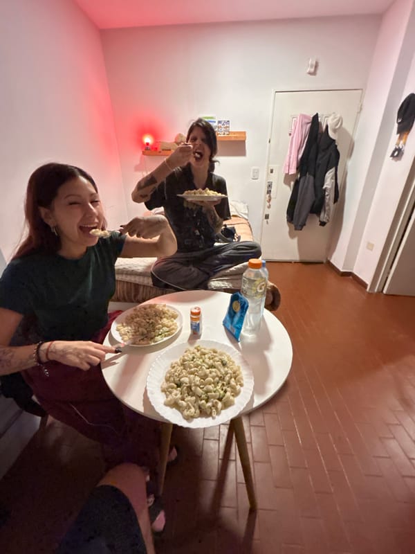 Two women share pasta dinner at Buenos Aires home
