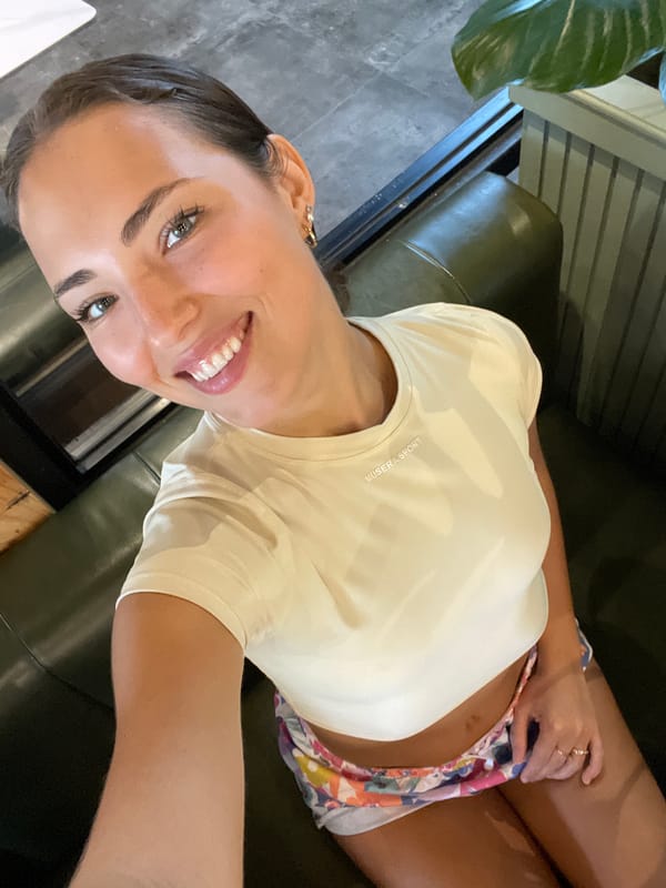 Woman documents breakfast at rustic cafe with salmon salads
