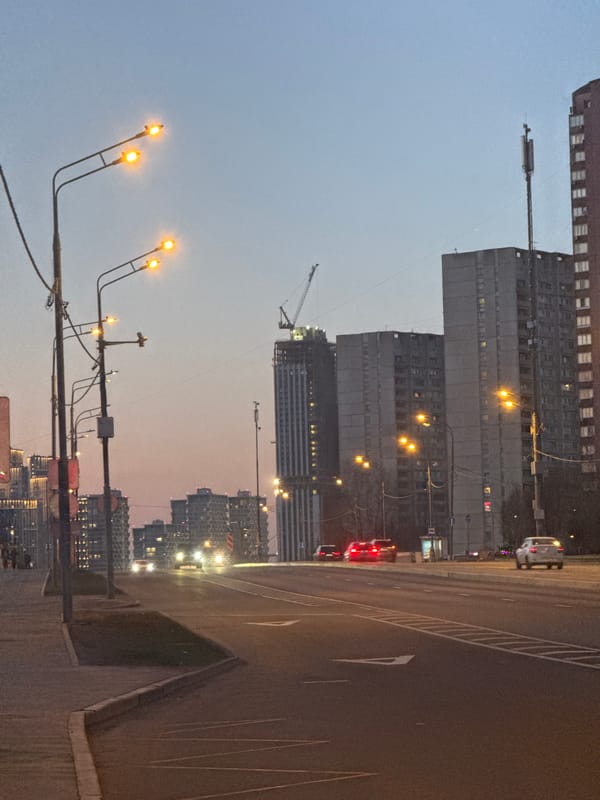 Moscow apartment buildings and construction cranes at dusk