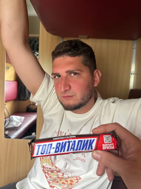 Passenger enjoys chocolate bar on morning train in Belarus