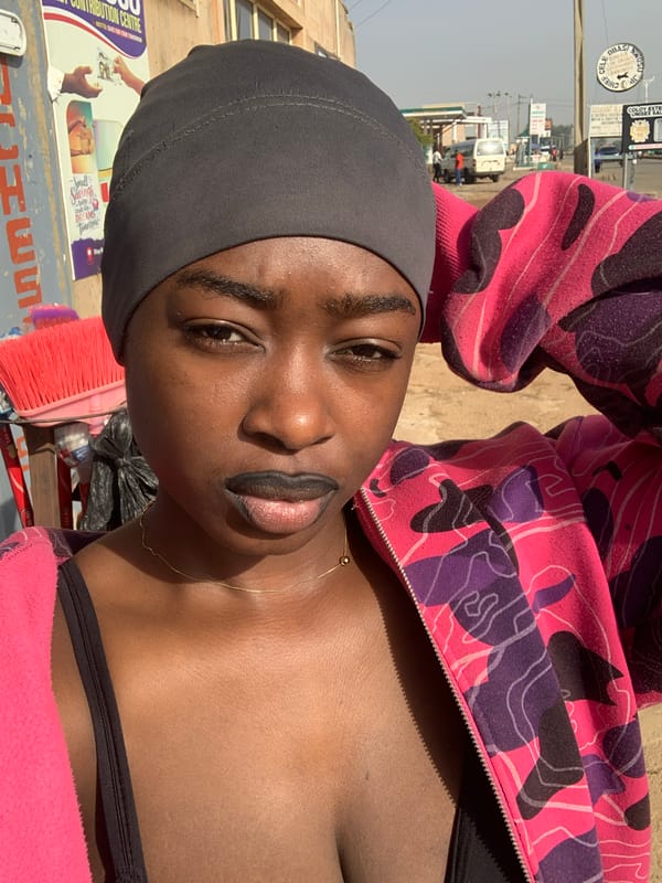 Woman photographed at street vendor stand in Jos, Nigeria