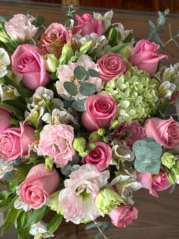 Mixed floral bouquet with pink roses observed at location