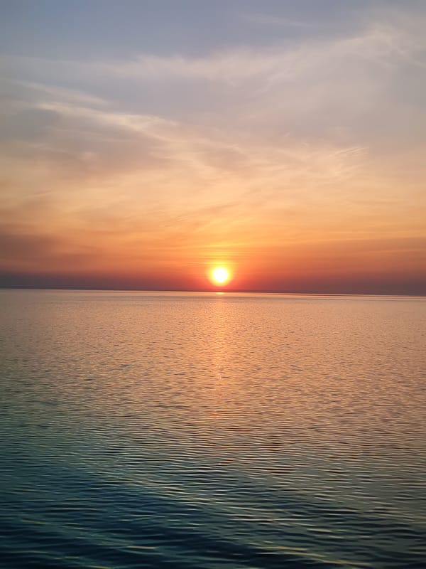 Sunset observed over water with vessel in Bol'shie Mkhi