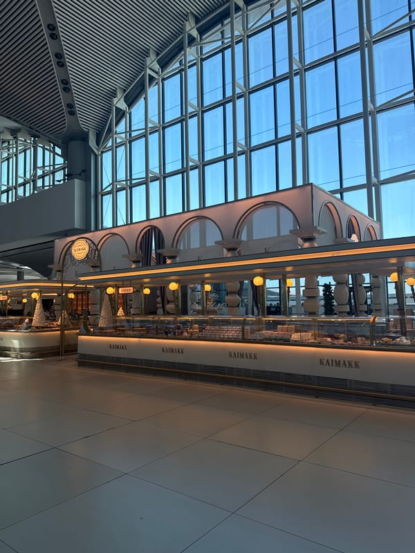 Moving through Istanbul Airport terminal with shopping bag in hand