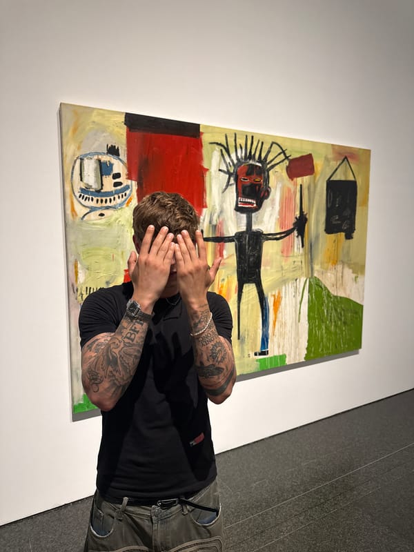 Tattooed figure poses before abstract art in Barcelona gallery