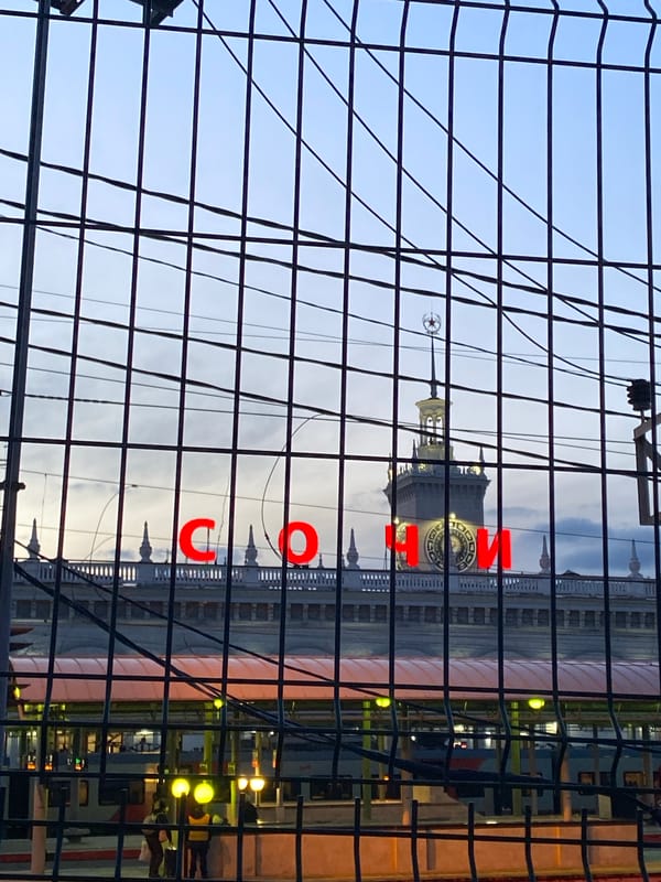 Sochi Sea Port building observed through fence under overcast sky