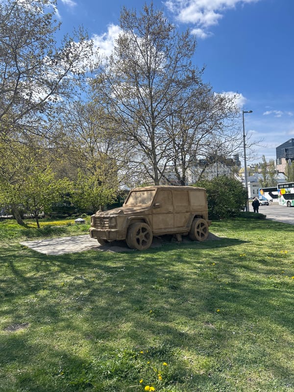 Concrete military jeep sculpture spotted on Vienna pathway