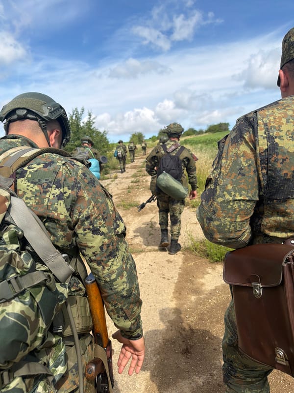 Soldiers on foot patrol along a dirt path in Bulgaria