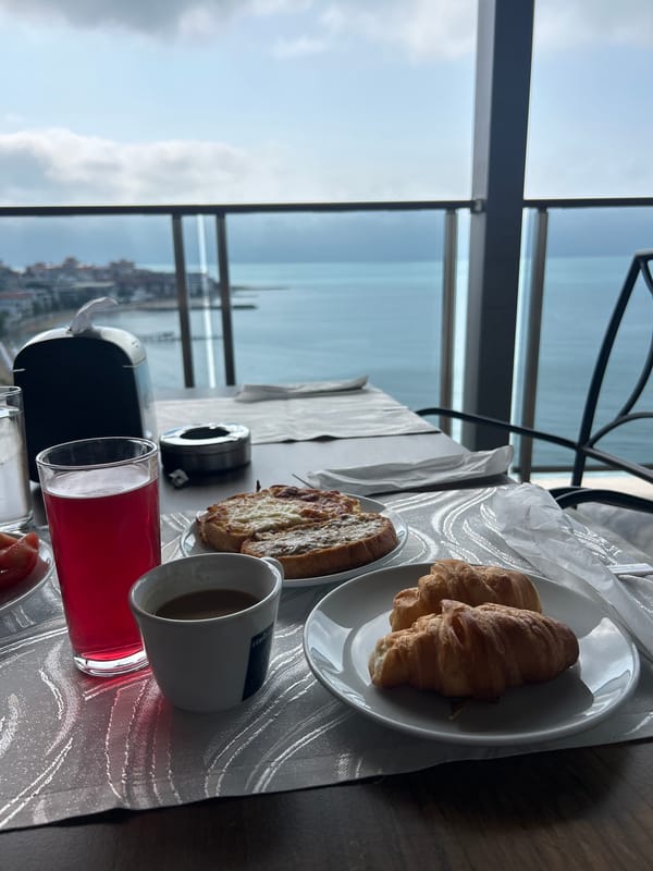 Morning breakfast setup captured with seaside panoramic view