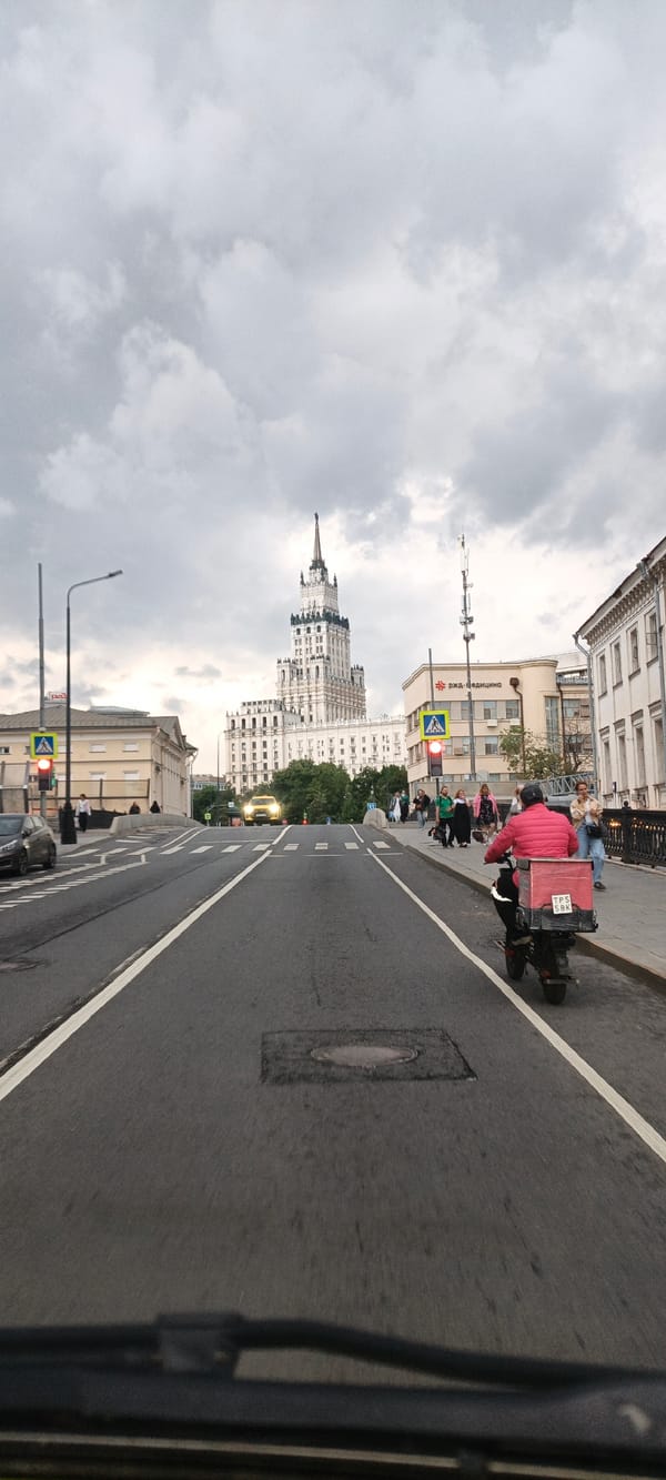 Driving toward a Stalinist skyscraper on a cloudy Moscow day
