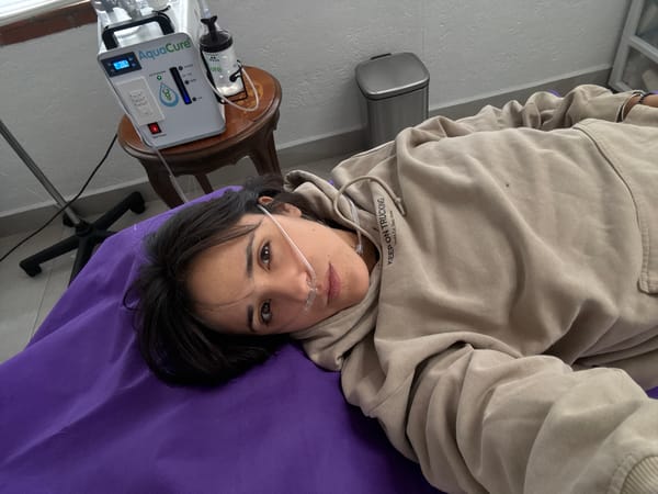 Woman receives medical treatment on purple table in Mexico City