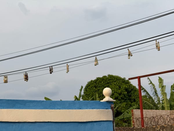 Glass bottles hang from power lines in Tinaquillo street