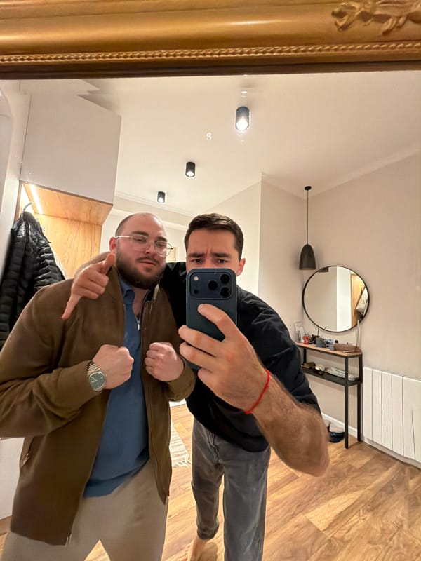 Two men take mirror selfie in Tbilisi