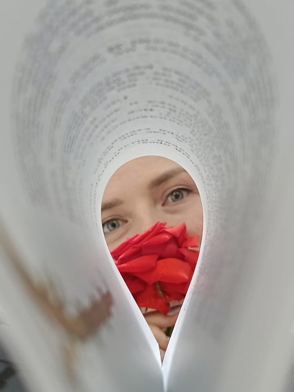 Reader photographed through open book pages in Rusalevka