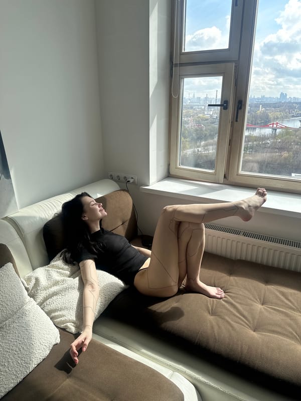 Woman relaxes by window in sunny Khimki apartment