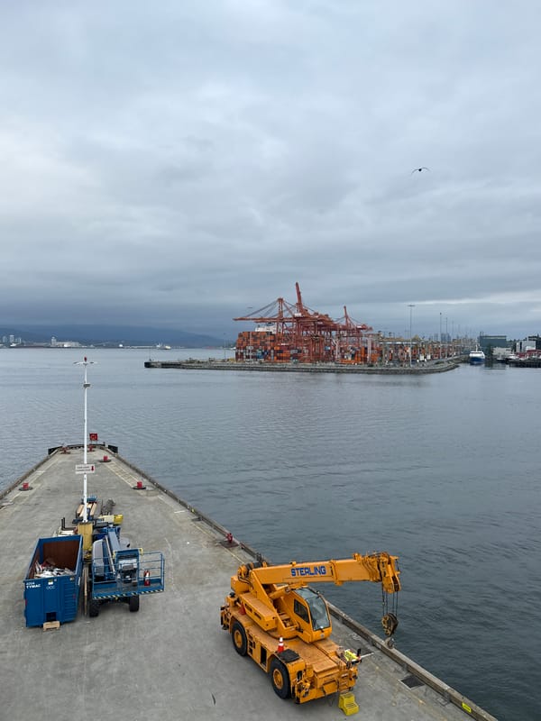 Seaplane departs Vancouver harbor amid industrial port scenery