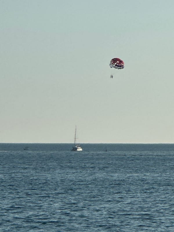 Parasailing and boats off the Budva coast on a summer afternoon