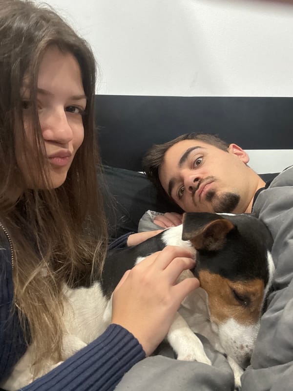 Person takes selfie in bed with dog in Sofia