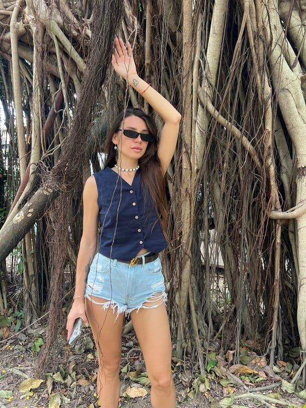Woman explores tropical beach and banyan trees in Thailand