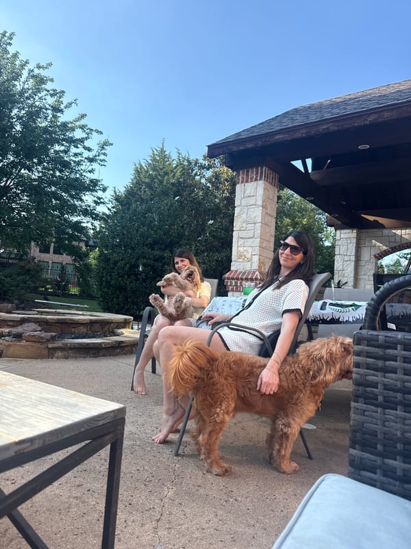 Woman enjoys evening with golden doodles in Southlake residence