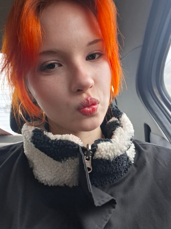 Orange-haired individual takes selfies in Chaikovsky, Russia