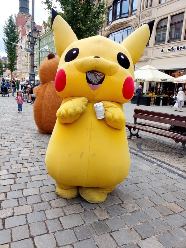Street festival with costumed characters and food vendors in Wrocław