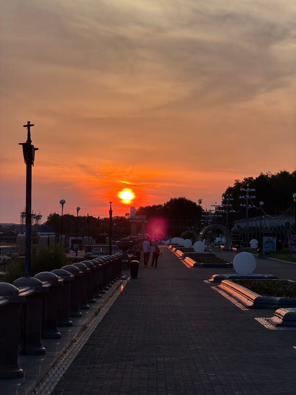Golden hour on Birobidzhan's promenade, people out enjoying the evening