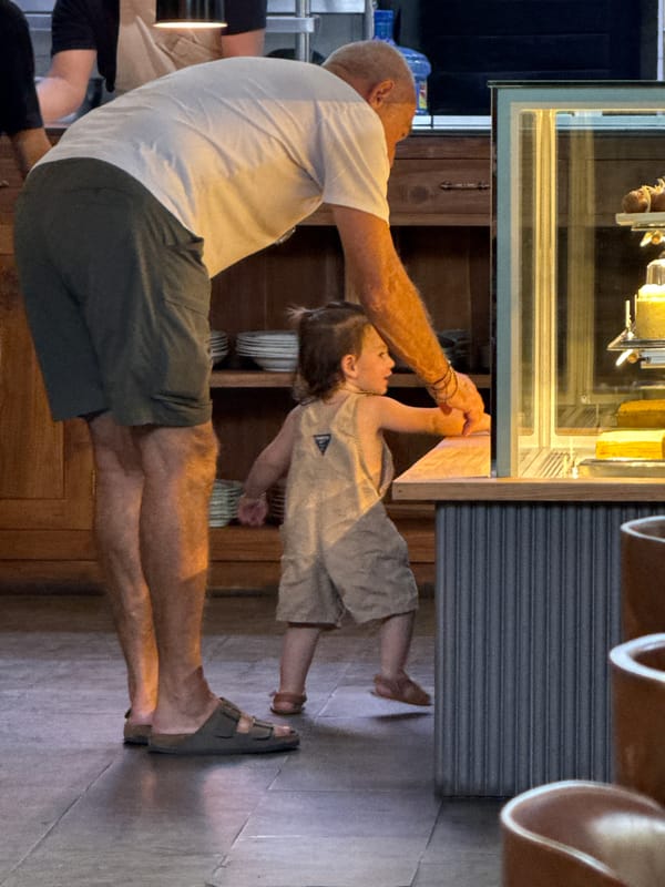 Father and child visit cafe kitchen in Ubud