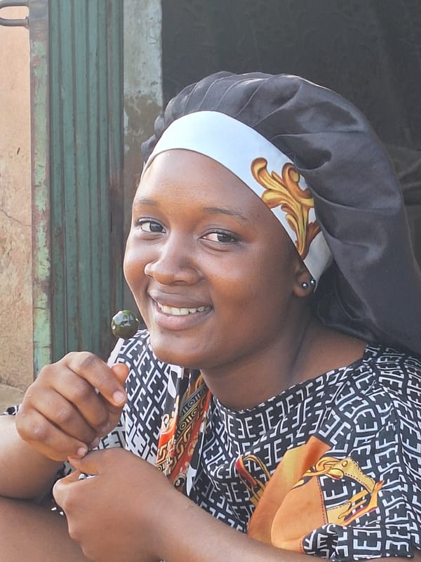 Woman in traditional dress observed across Sabon Tasha locations