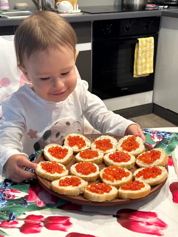 Child examines caviar-topped bread breakfast in Wisła, Poland