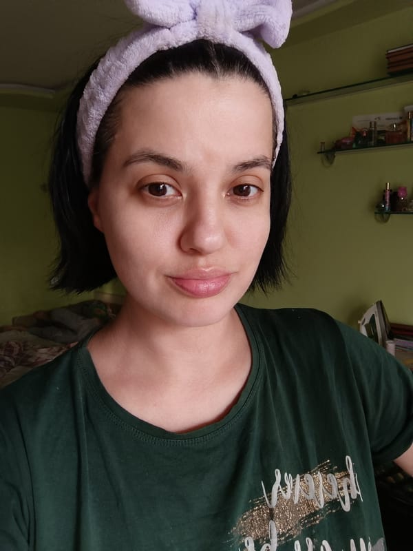 Person in green shirt photographed at unknown location