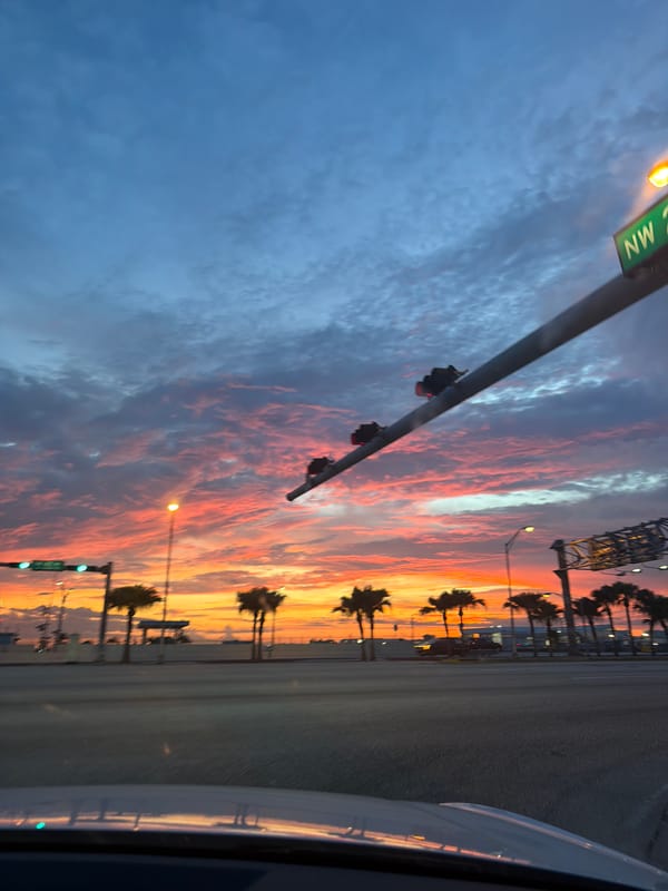 Sunset drive through Miami with dramatic colorful sky