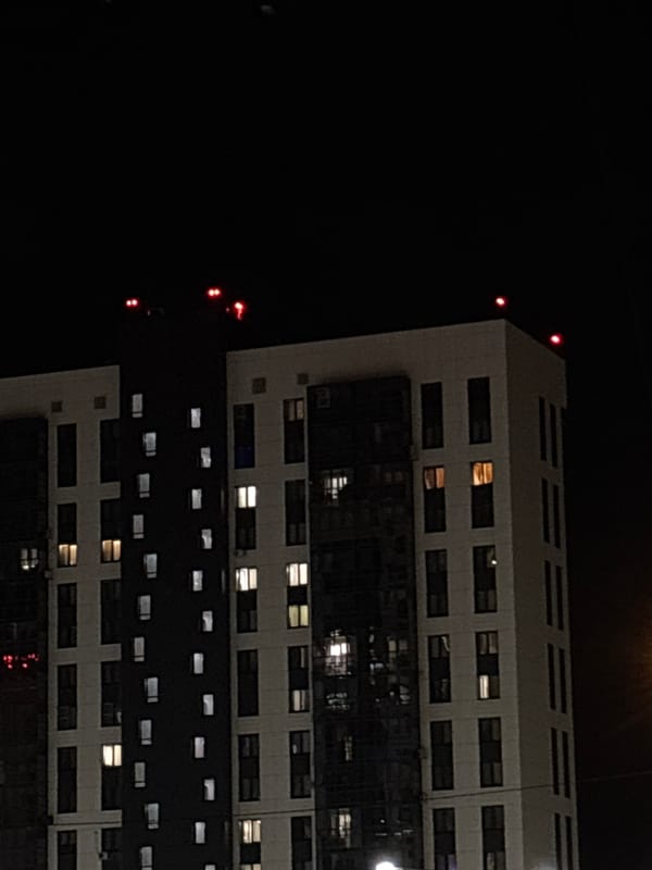 Kazan apartment building at night, with a fleeting green light