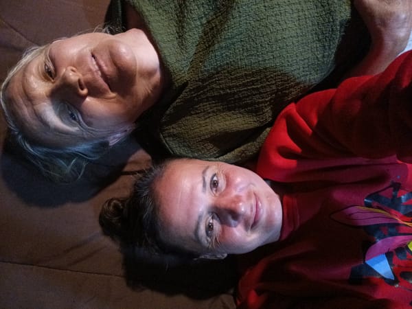 Two women share quiet moment resting in Thai village