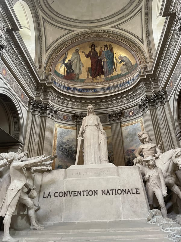 Visitor photographs La Convention Nationale statue at Paris Panthéon