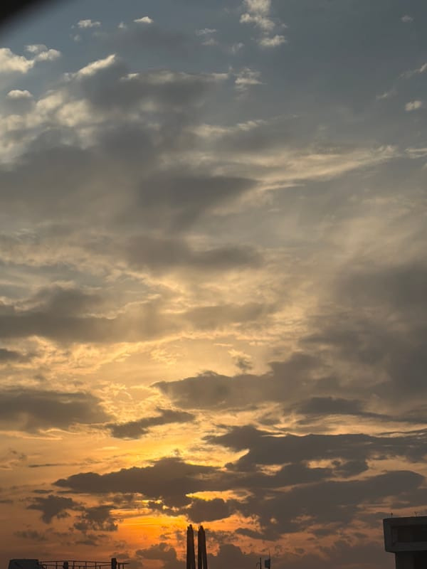 Sunset sky with orange-blue clouds observed in Ferno, Italy