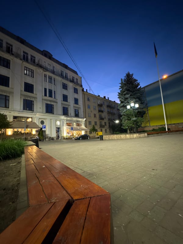 Chernivtsi city center at dusk, square and streets lit up