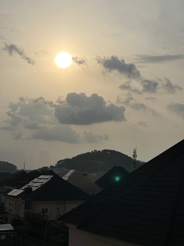 Hazy golden sunset settles over an Abuja residential neighborhood