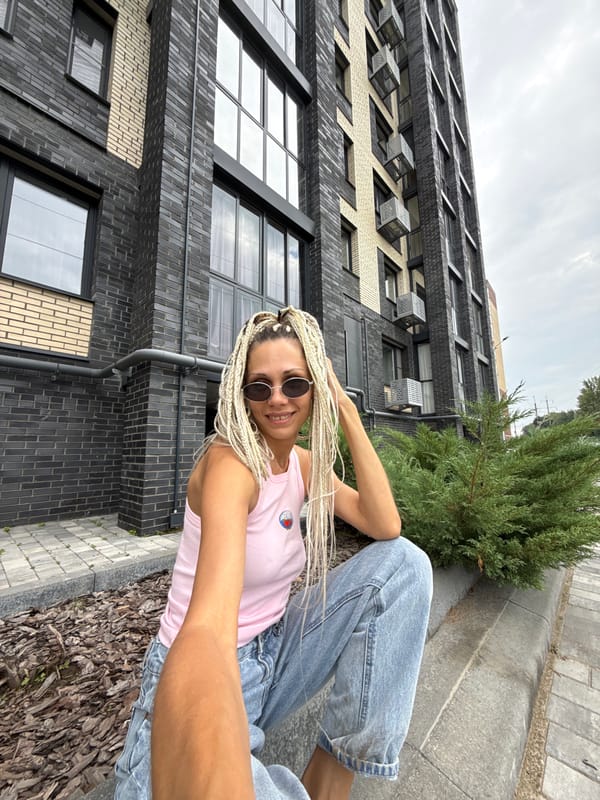 Casual moments outside a modern brick building in Rusanovo