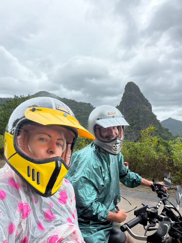Rainy-day motorcycle selfie in rural Vietnam