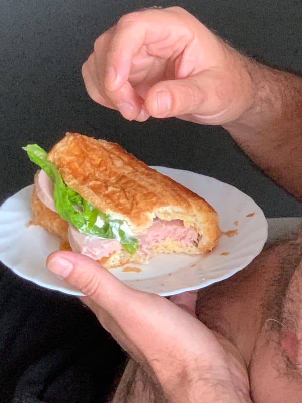 Croissant sandwich and coffee on a café table in Kapyĺ