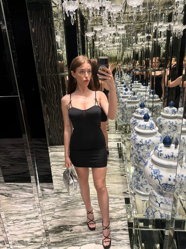 Woman takes mirror selfie at Sofia hotel restroom