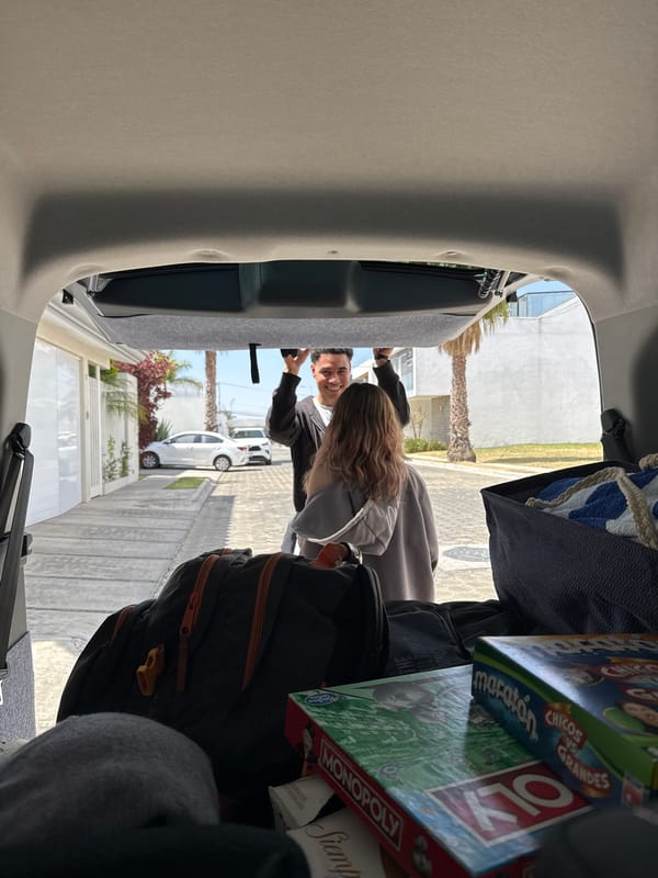 Friends gather at car with games and supplies