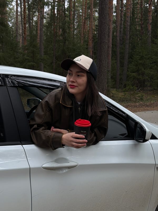 Woman photographed leaning from car window near Russian forest