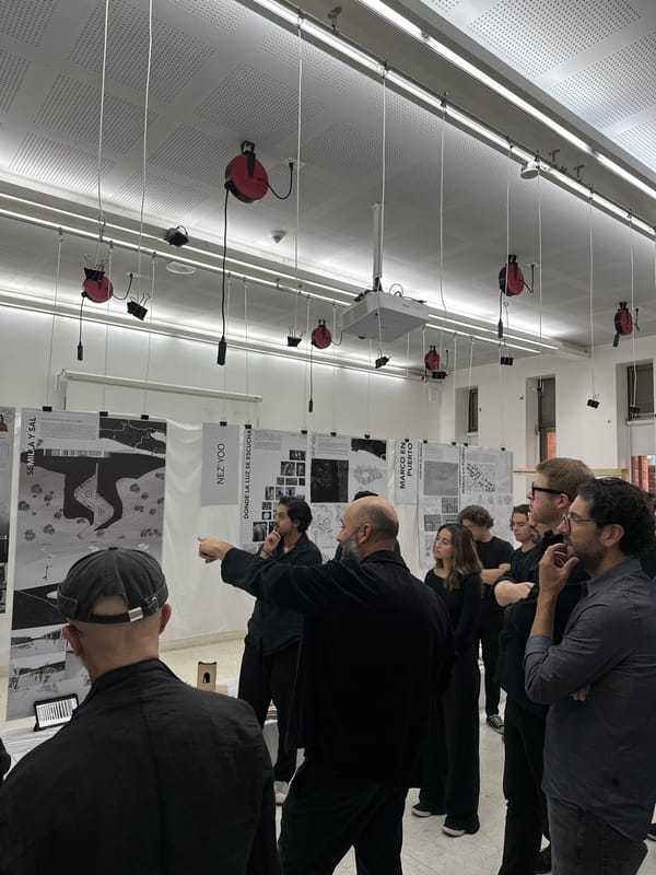 Design students examine architectural posters at Mexico City university exhibition
