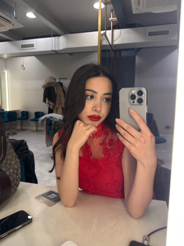 Woman takes mirror selfie in Yerevan interior location
