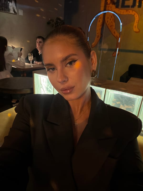 Woman photographs selfie at Krasnoyarsk restaurant