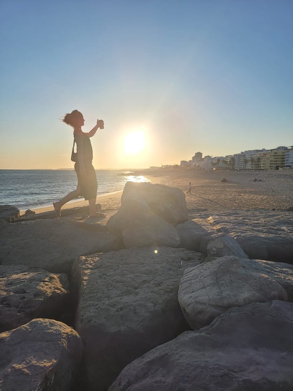 Sunset hour on Quarteira's rocky Atlantic shore