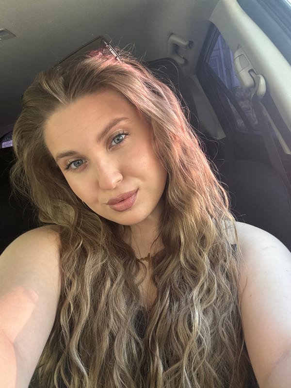 Woman takes morning selfies in car with sunroof in Omsk