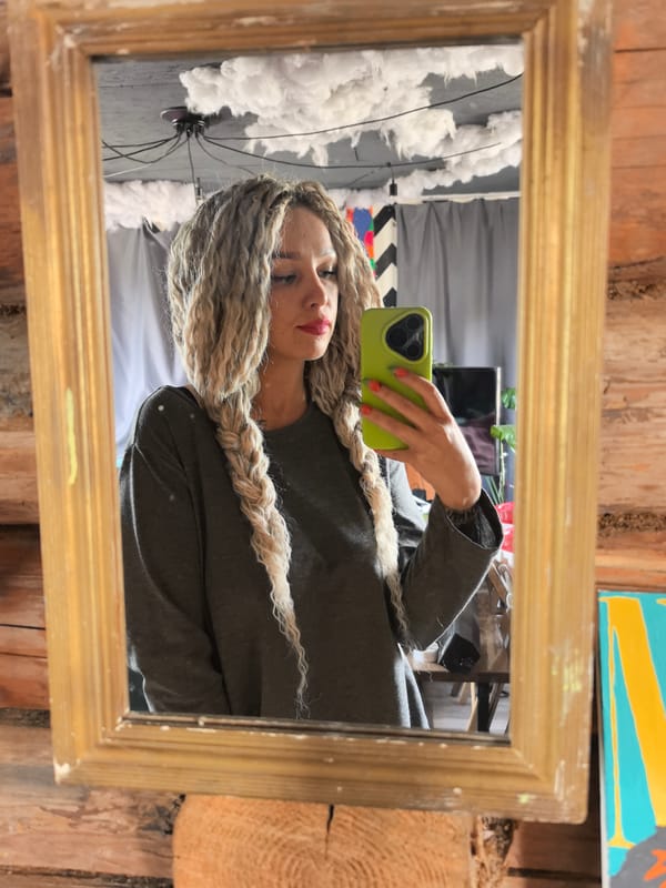 Woman takes mirror selfie with green phone in Russia